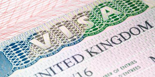 Can a skilled worker travel to the UK on the skilled worker visa or a business visa?